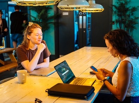 Two attendees working together at the big table